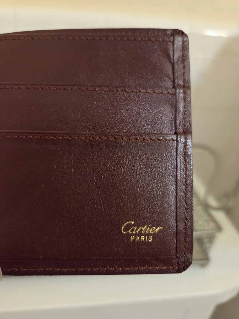 Cartier Leather Bifold Wallet in Deep Maroon with Gold Corner Accents